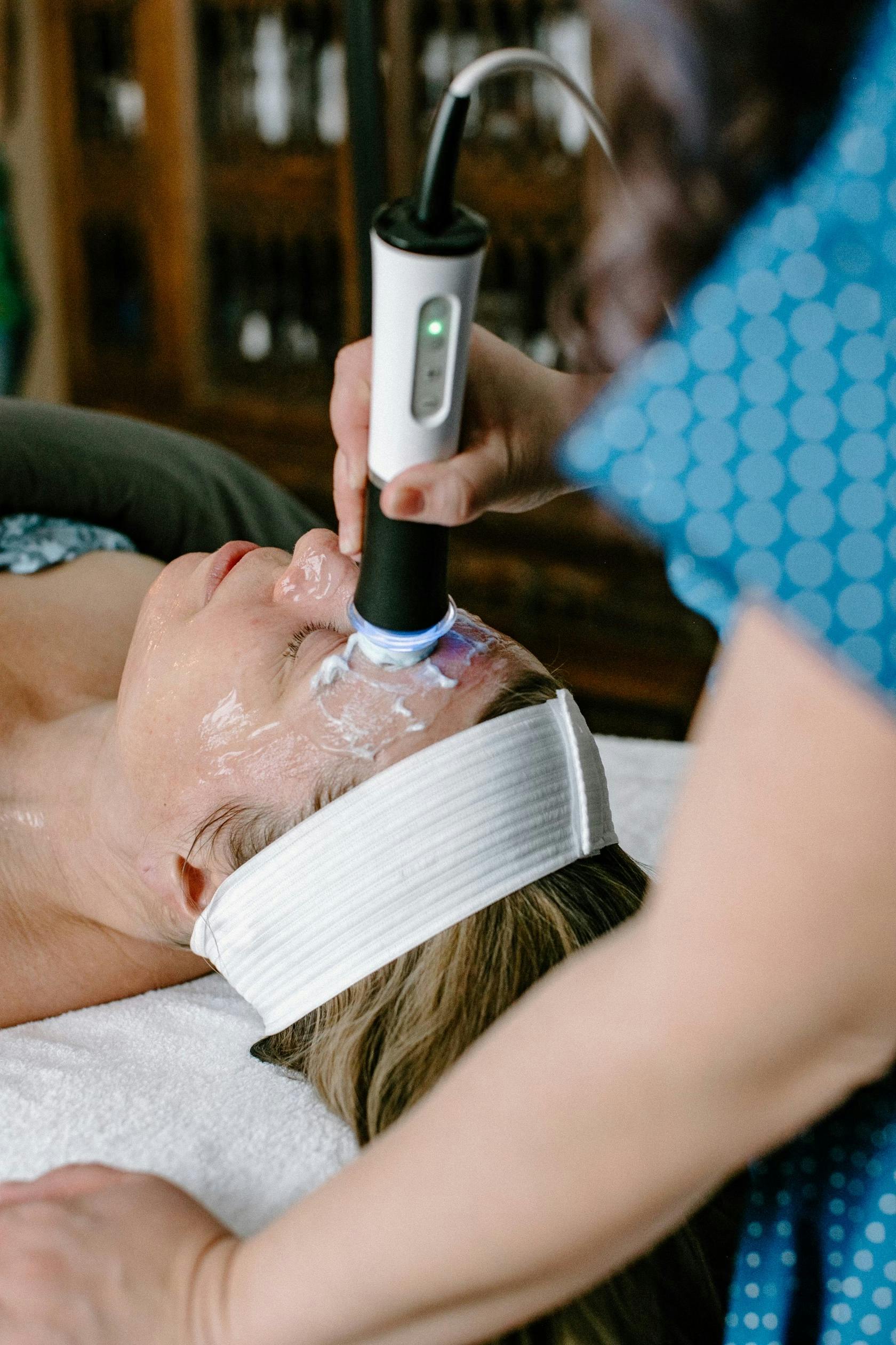 Woman receiving treatment with the Glo2Facial machine